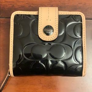 Black patent leather Coach wallet with tan trim